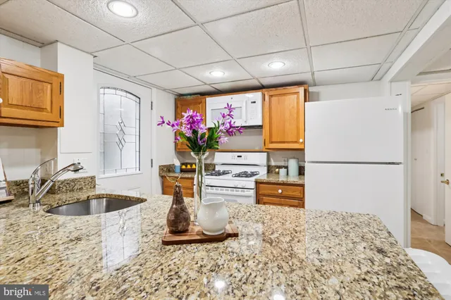 a view of a brick house with many windows and plants