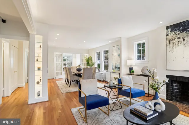 a kitchen with stainless steel appliances granite countertop a refrigerator a stove a sink dishwasher and a dining table with wooden floor