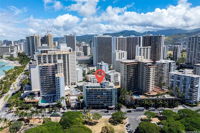 an aerial view of multiple houses with yard