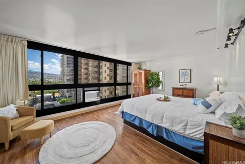 a bedroom with a bed and wooden floor