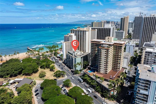 a bedroom with a bed and large windows