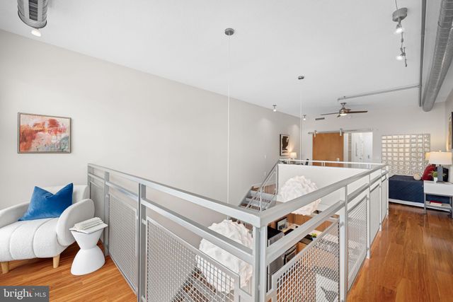 a bathroom with a granite countertop sink a toilet a mirror and shower