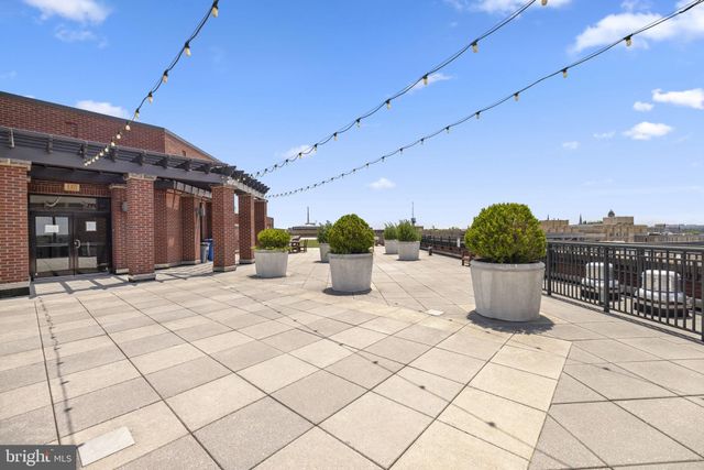 a view of a terrace with furniture and city view