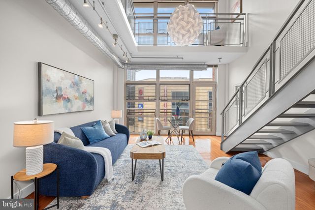 a living room with furniture and a floor to ceiling window