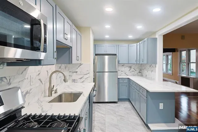 a kitchen that has a sink and a stove