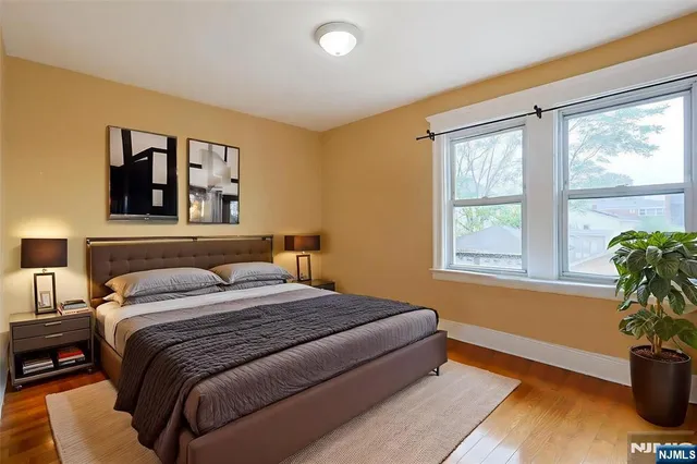a bedroom with a bed and a potted plant