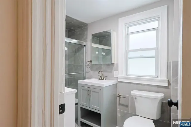 a bathroom with a sink toilet and mirror
