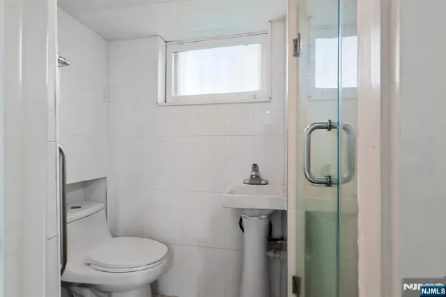 a bathroom with a toilet a sink and shower