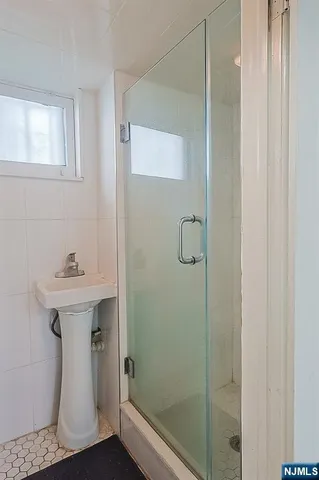 a bathroom with a sink a mirror and shower