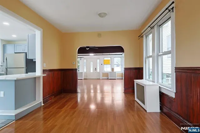 a view of a room with wooden floor and furniture