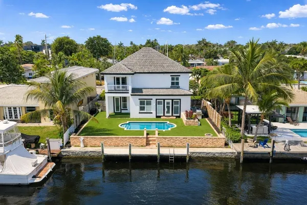 a aerial view of a house with swimming pool and a yard
