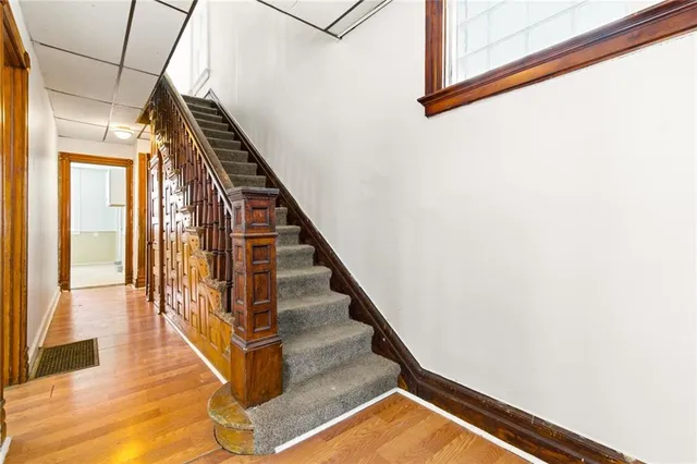 a view of entryway and hall with wooden floor