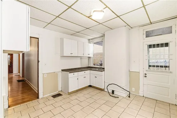 a kitchen with granite countertop white cabinets and white appliances