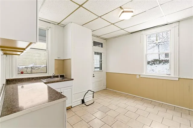 a kitchen with a stove a sink and a refrigerator