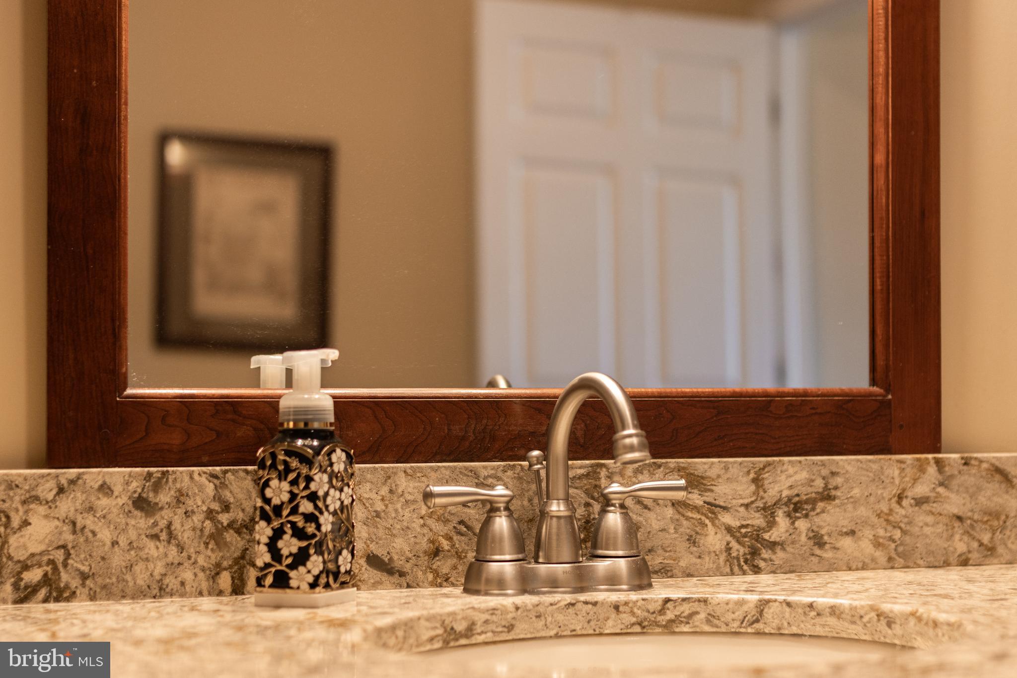 169 Quarry Street Bellefonte, PA 16823 - Photo 19 of 30 a bathroom with a granite countertop sink and a mirror