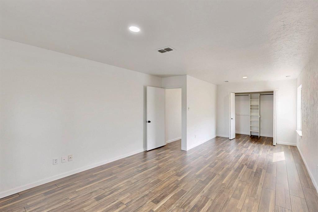 3965 Singleleaf Lane Fort Worth, TX 76133 - Photo 24 of 39 Spacious room with wood-finish flooring, recessed lighting, and white walls