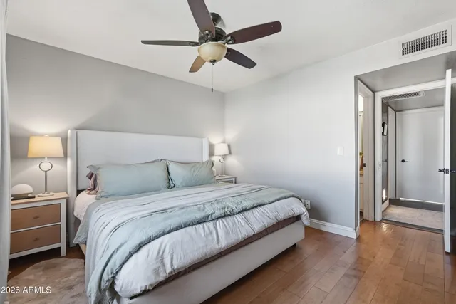 a bedroom with a bed and a ceiling fan