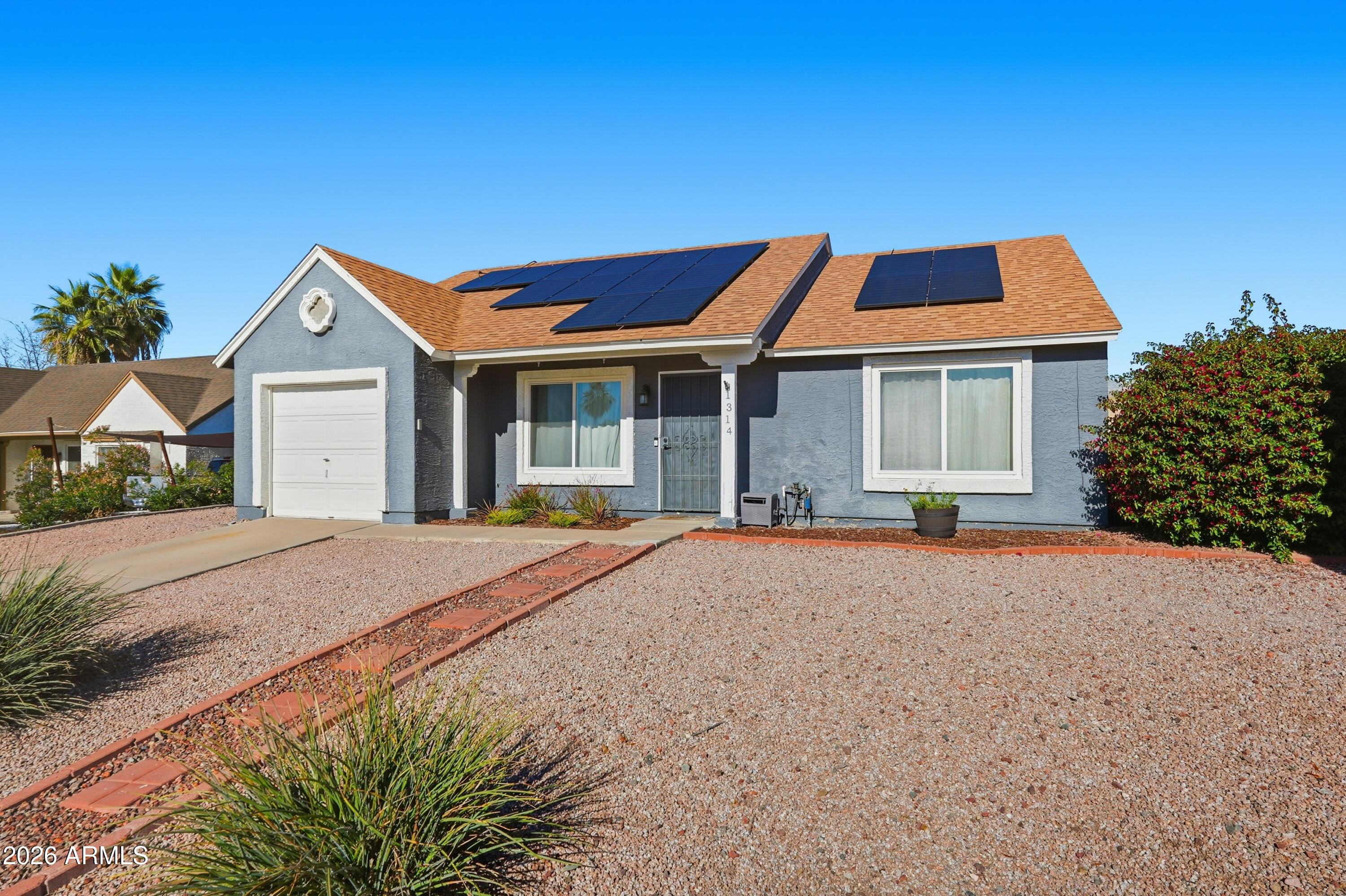 1314 East Utopia Road Phoenix, AZ 85024 - Photo 2 of 33 a front view of a house with a yard and garage
