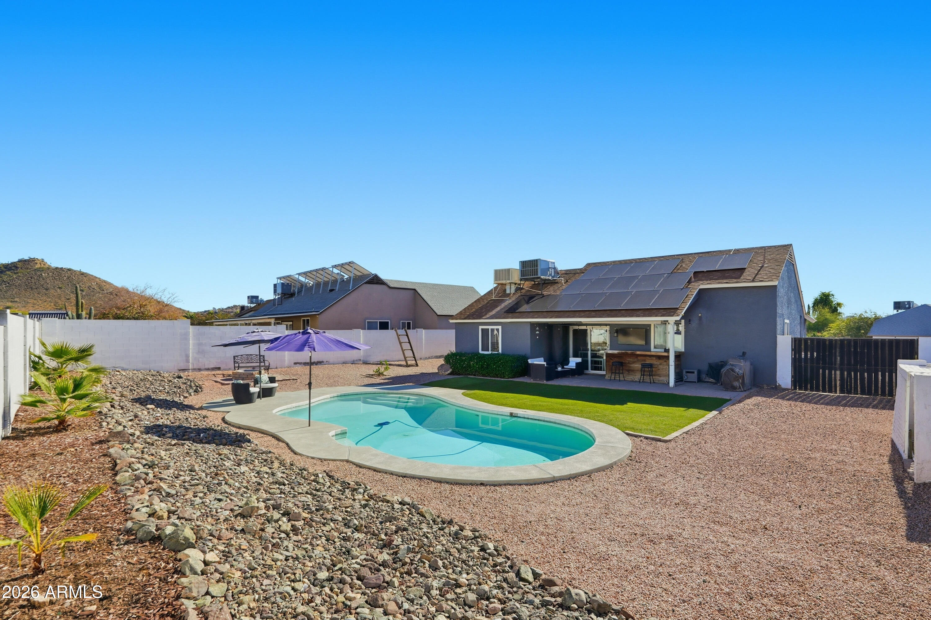 1314 East Utopia Road Phoenix, AZ 85024 - Photo 29 of 33 a view of a house with swimming pool and a yard