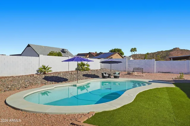 a swimming pool with outdoor seating and yard