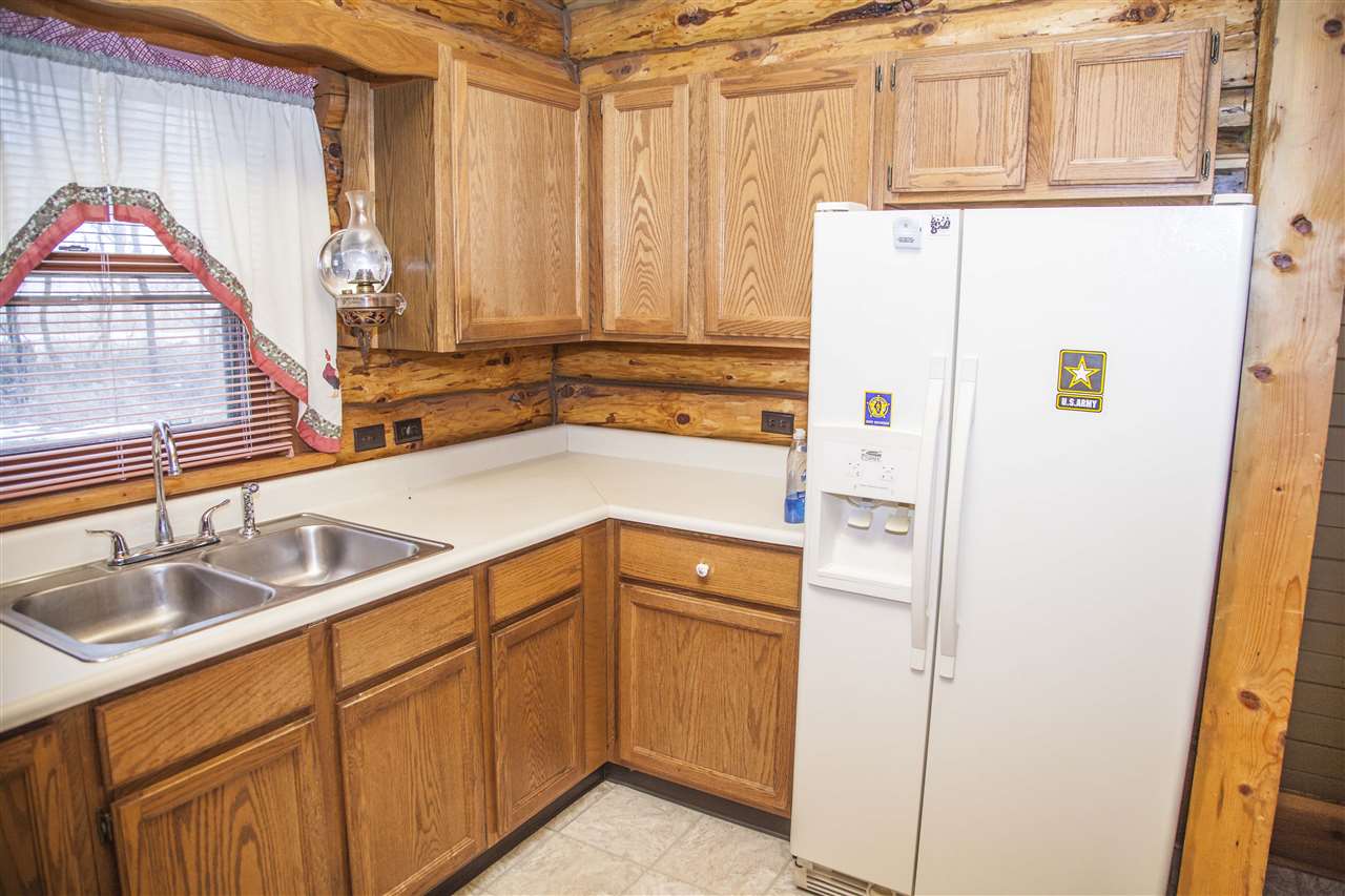 13026 West State Road Winnebago, IL 61088 - Photo 3 of 24 a kitchen with a sink and a refrigerator
