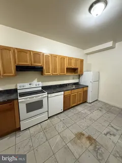 a kitchen with a stove a sink and a microwave