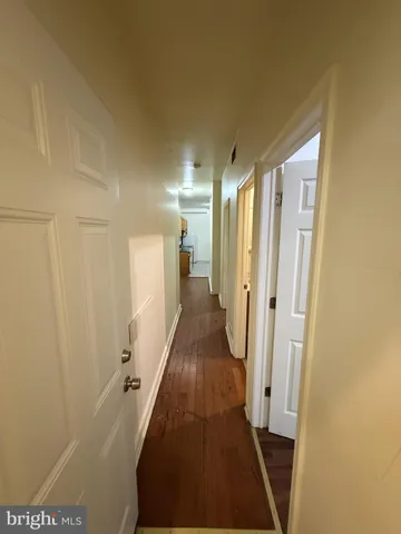 a view of hallway with wooden floor
