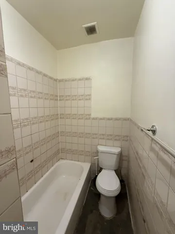 a bathroom with a toilet and a bathtub