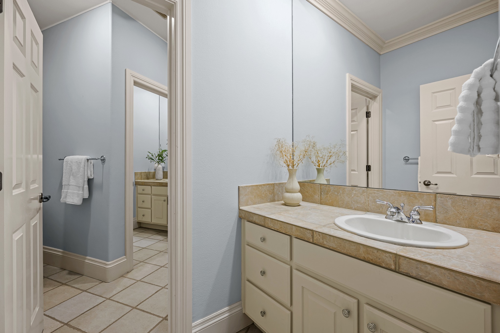 5200 Rico Cove Austin, TX 78731 - Photo 24 of 40 Elegant crown molding complements the vanity area with views extending to a secondary bathroom.