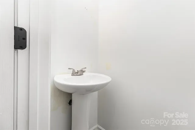 a bathroom with a sink a mirror and vanity