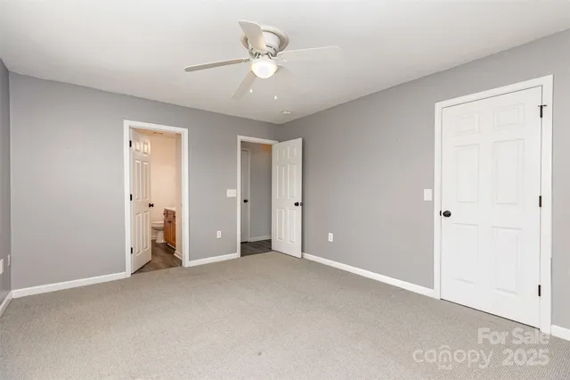 a view of an empty room with a ceiling fan
