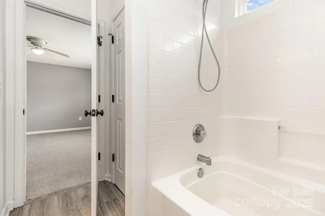 a bathroom with a bath tub with shower