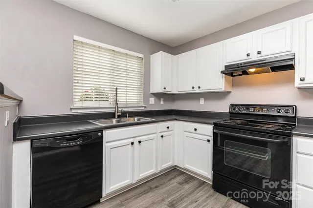 a kitchen with granite countertop a stove and a sink