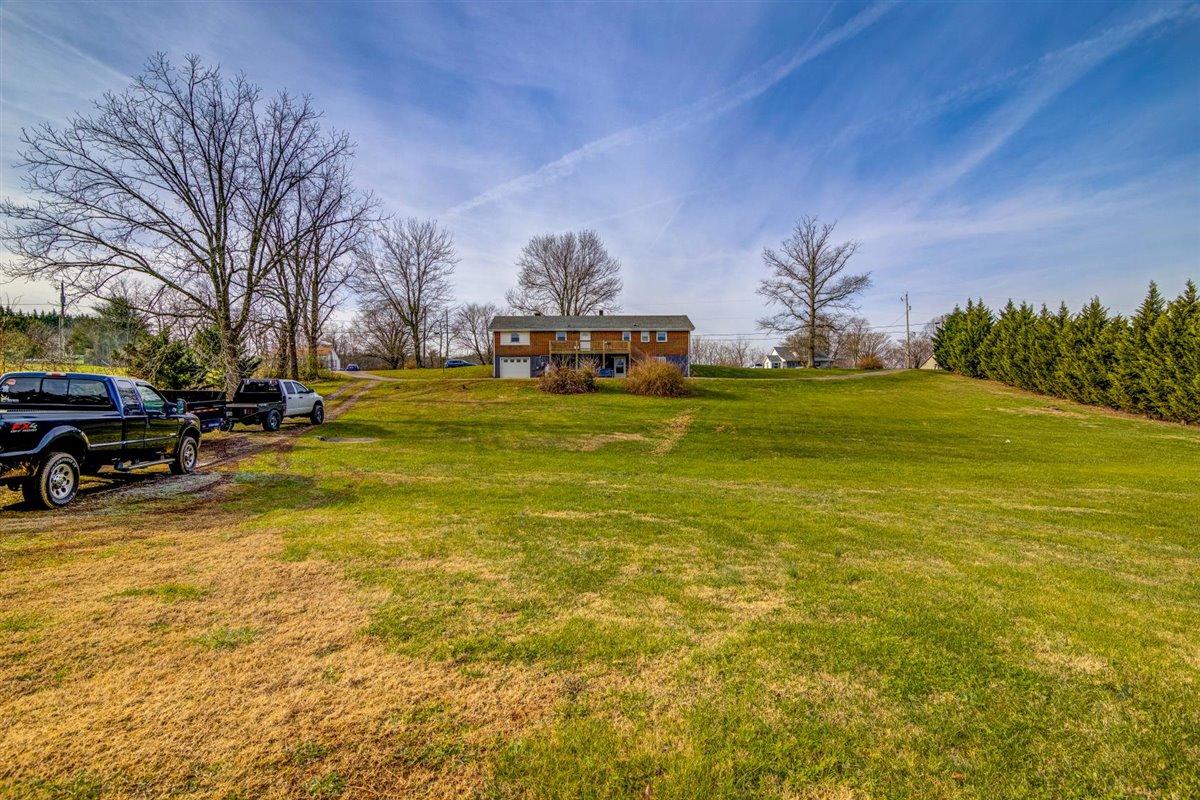 1358 Sandy Level Road Goodview, VA 24095 - Photo 22 of 39 a swimming pool with outdoor seating and yard