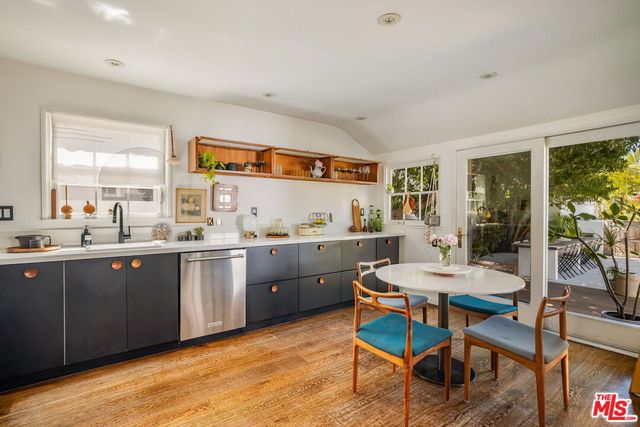 a kitchen with a sink cabinets and wooden floor