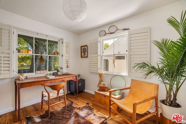 a living room with a table chair and a window
