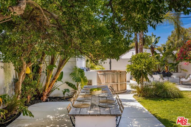 a backyard of a house with table and chairs