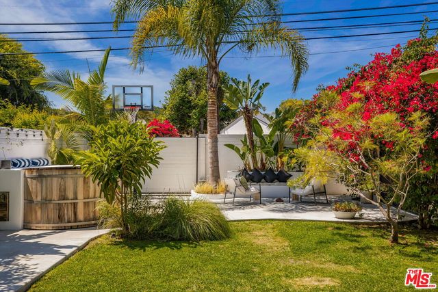 a view of backyard with plants and outdoor seating