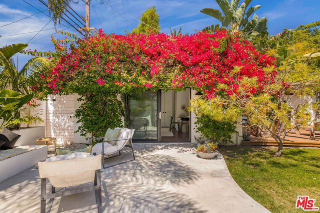 a view of a chair and tables in the patio