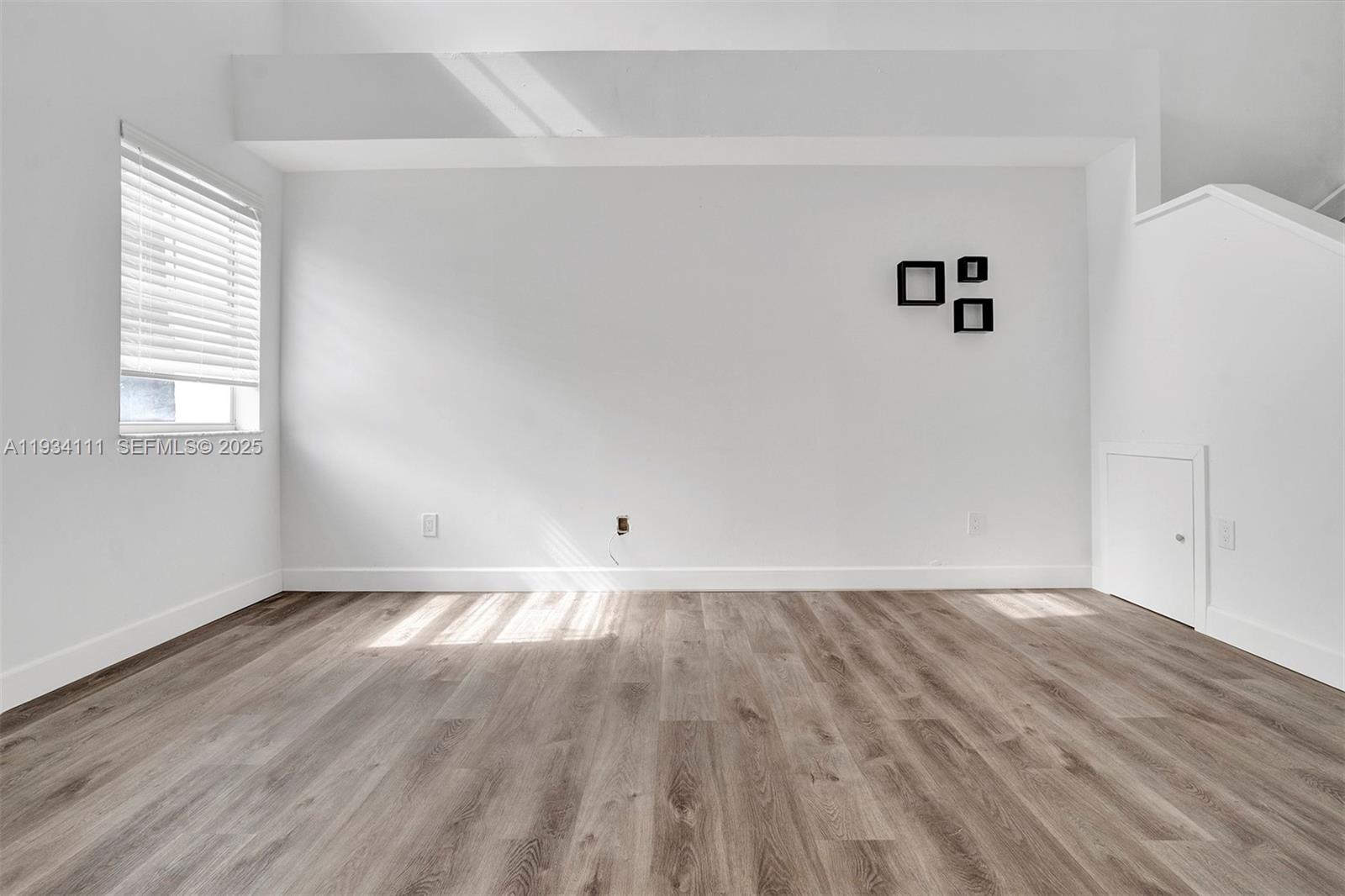 20985 Southwest 84th Avenue Cutler Bay, FL 33189 - Photo 20 of 36 a view of an empty room with wooden floor and a window
