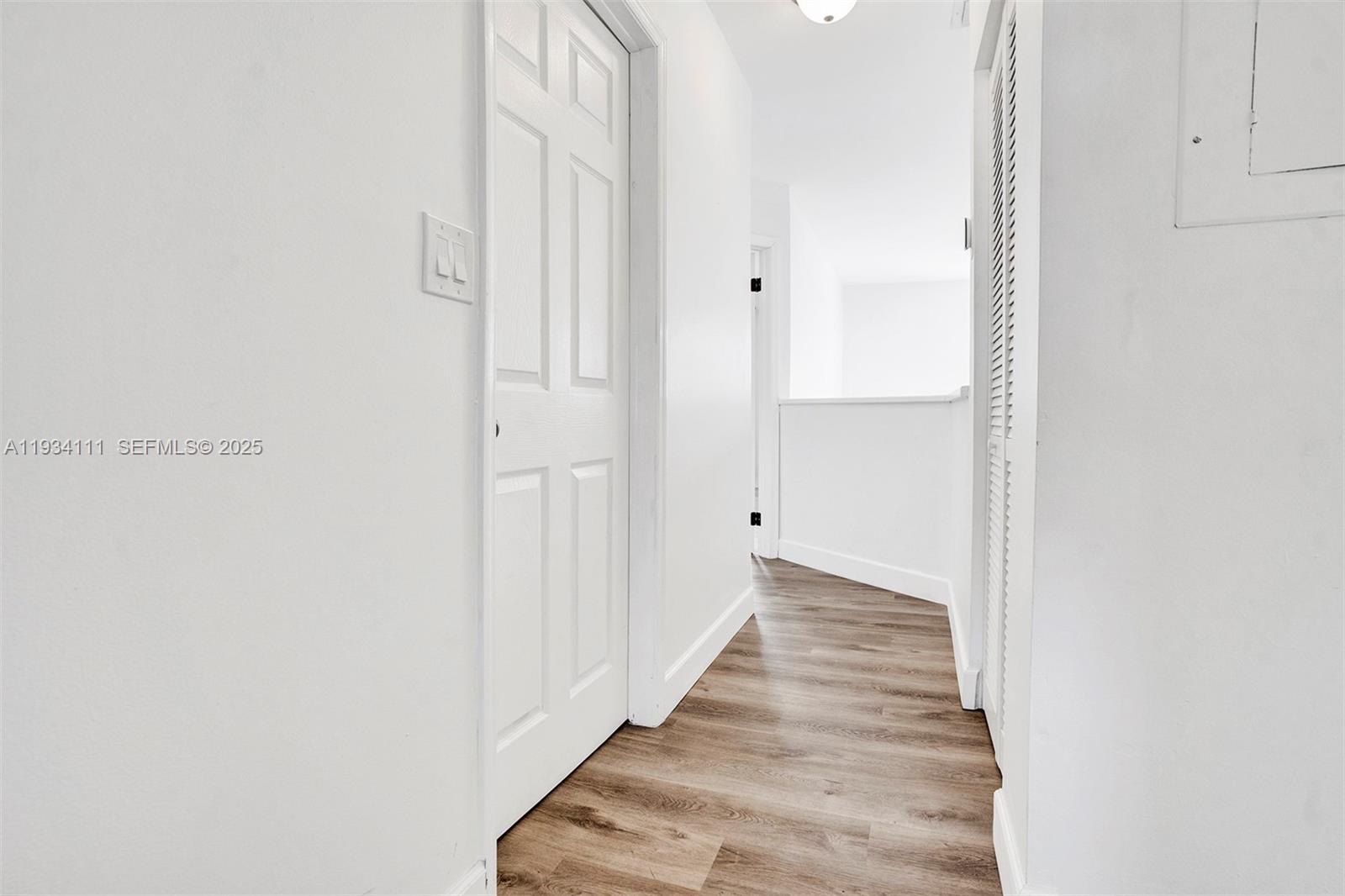 20985 Southwest 84th Avenue Cutler Bay, FL 33189 - Photo 24 of 36 a view of a hallway with wooden floor