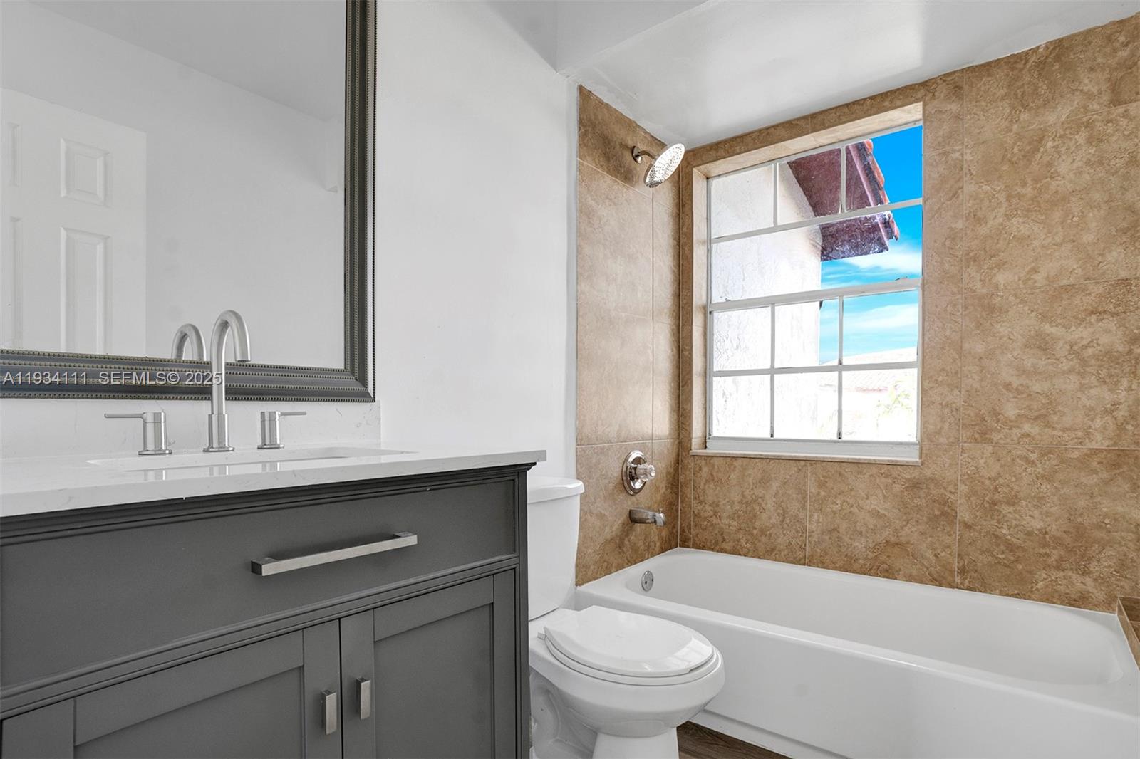 20985 Southwest 84th Avenue Cutler Bay, FL 33189 - Photo 28 of 36 a bathroom with a sink a toilet and a bathtub