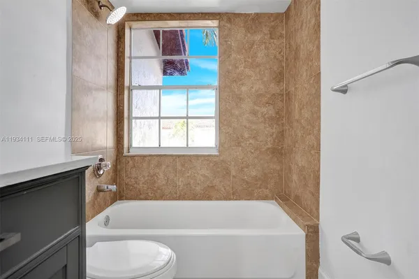 a bathroom with a bathtub and window