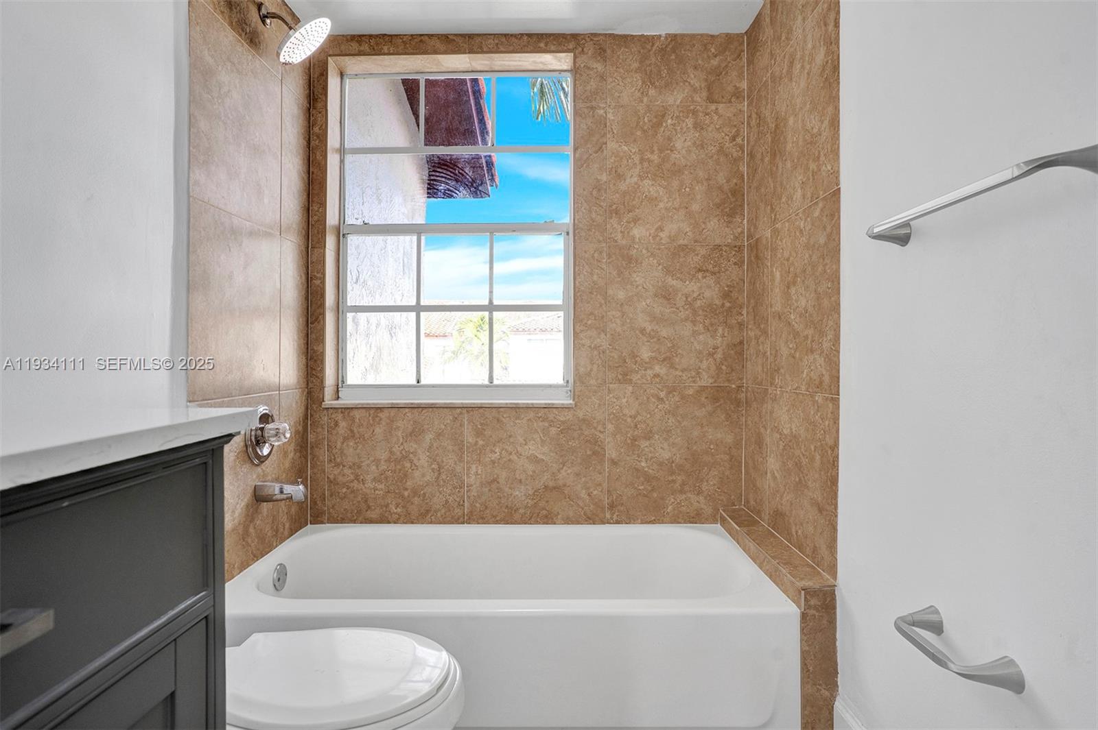 20985 Southwest 84th Avenue Cutler Bay, FL 33189 - Photo 29 of 36 a bathroom with a bathtub and window