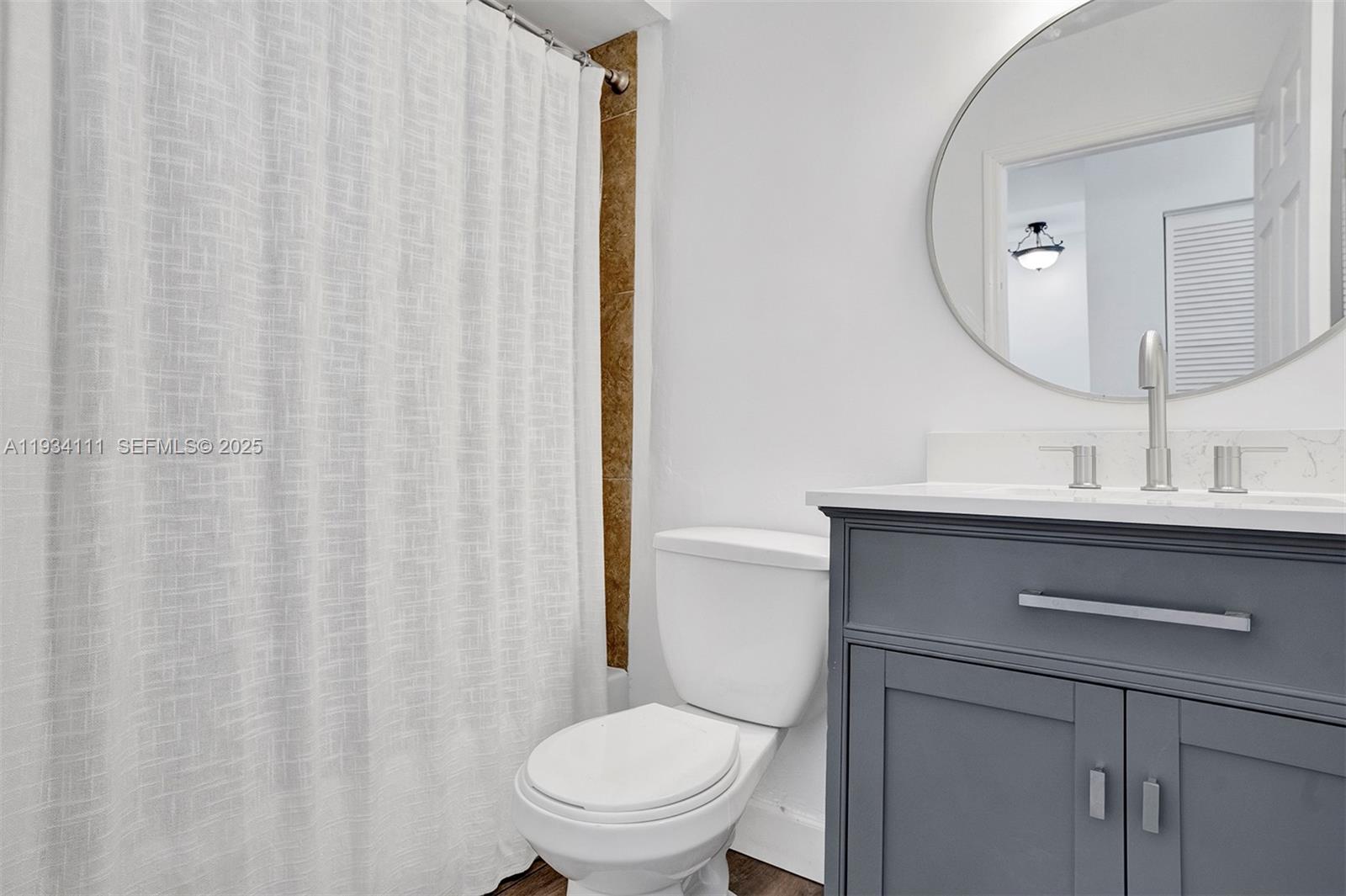 20985 Southwest 84th Avenue Cutler Bay, FL 33189 - Photo 31 of 36 a bathroom with a toilet a sink and a mirror