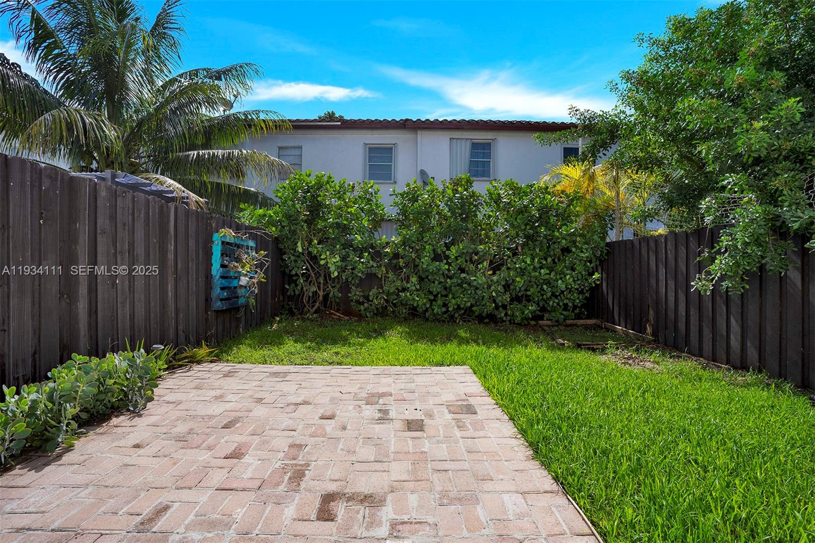 20985 Southwest 84th Avenue Cutler Bay, FL 33189 - Photo 34 of 36 a view of a back yard with a wooden fence