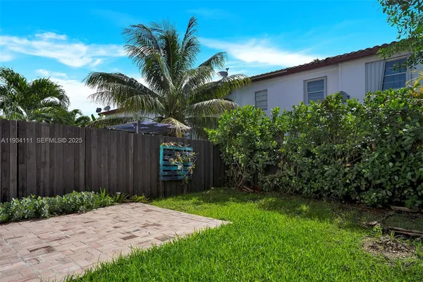 a view of a backyard with potted plants