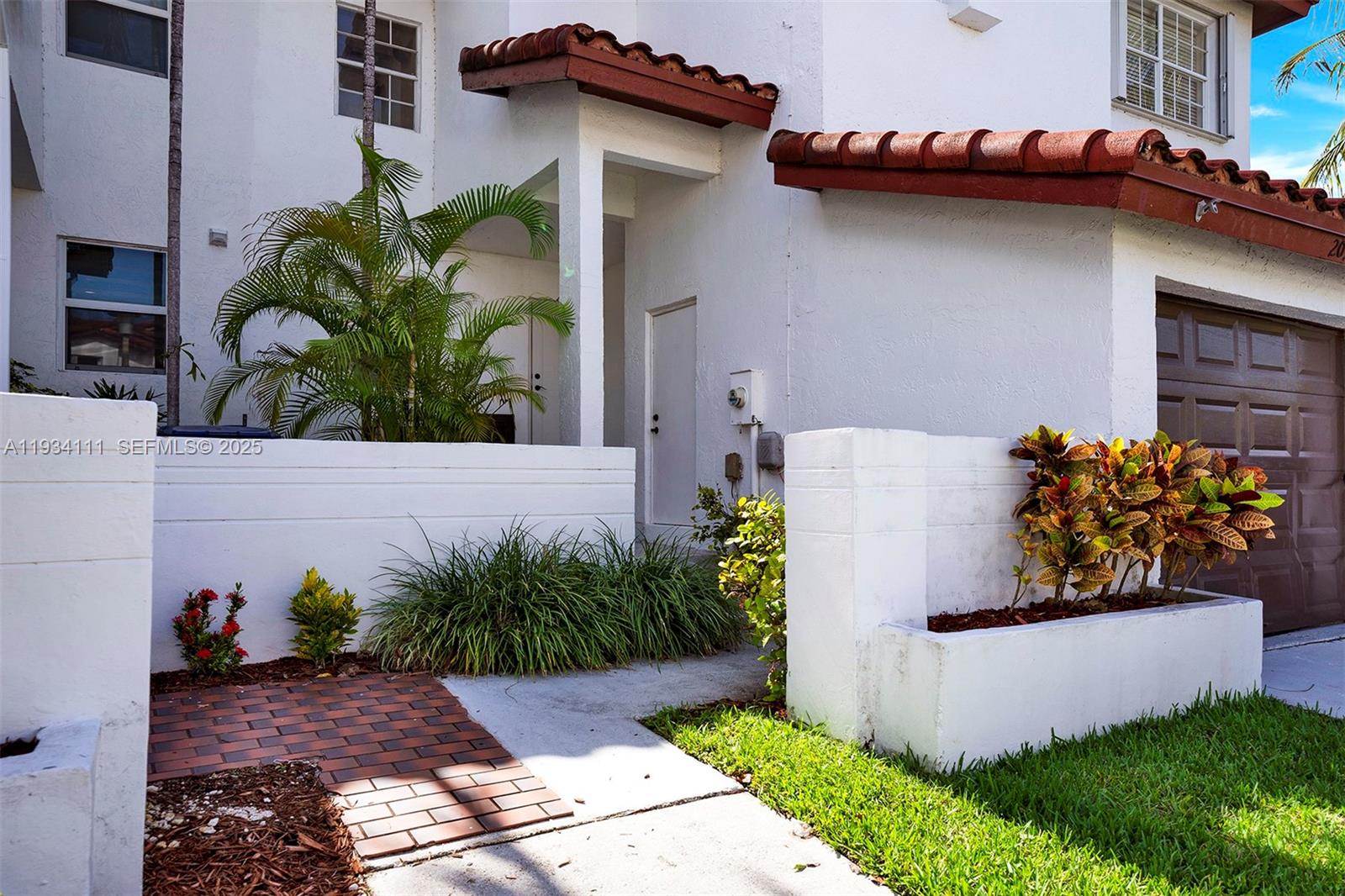20985 Southwest 84th Avenue Cutler Bay, FL 33189 - Photo 9 of 36 a view of a house with potted plants