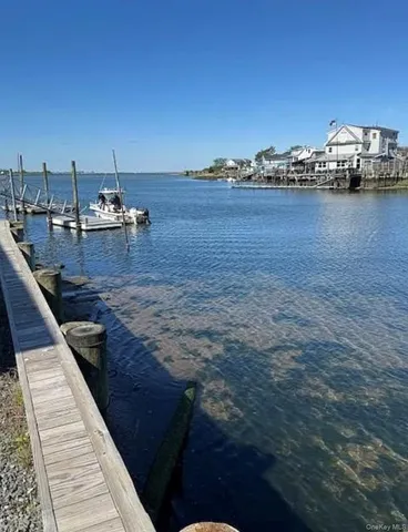 a view of a terrace with lawn chairs
