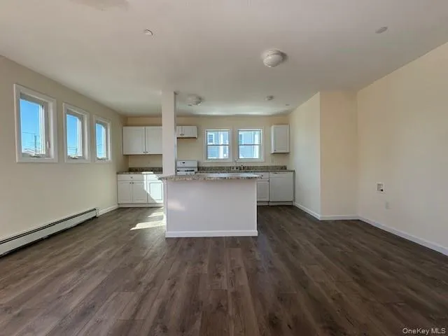 a view of kitchen with wooden floor and electronic appliances